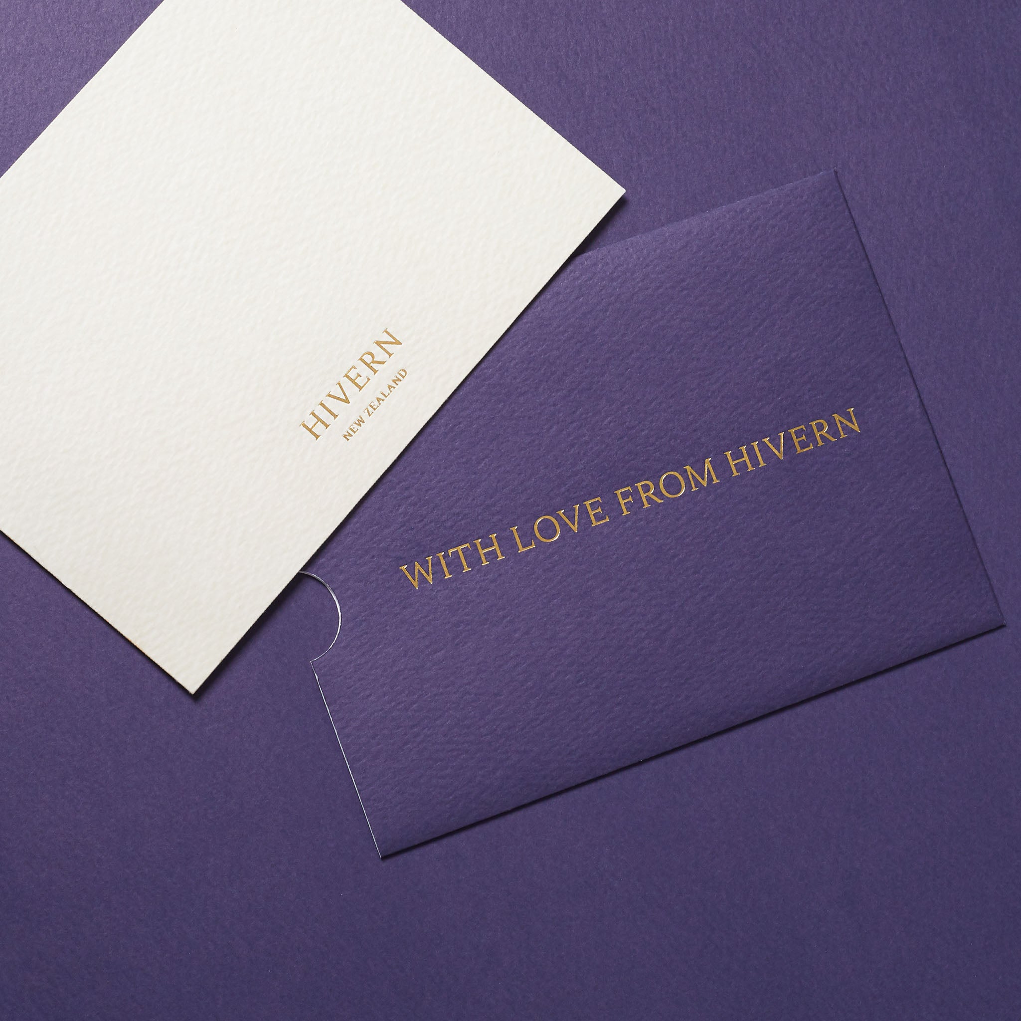 A gift card envelope is displayed alongside the corresponding gift card. The card is emblazoned with a Hivern New Zealand logo in gold foil, and the envelope displays "With Love From Hivern" across it's front in the same gold foil.